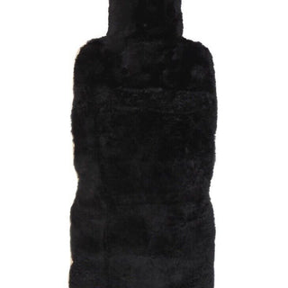 An Eastern Counties black sheepskin hot water bottle on a white background.