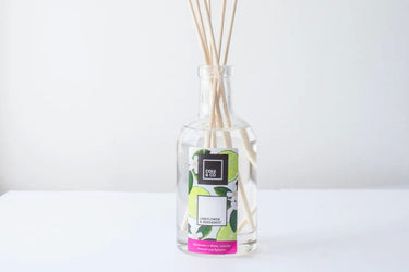 A bottle of Cole & Co Lime Flower & Bergamot diffuser by Anna Davies on a white table.