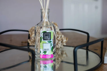 A bottle of Cole & Co Lime Flower & Bergamot Diffuser, scented with lime flower, sits on a table. (Brand: Anna Davies)