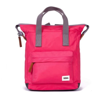 A pink Roka Bantry B Small Sustainable Nylon Bag with grey handles and straps by Roka London Bags.