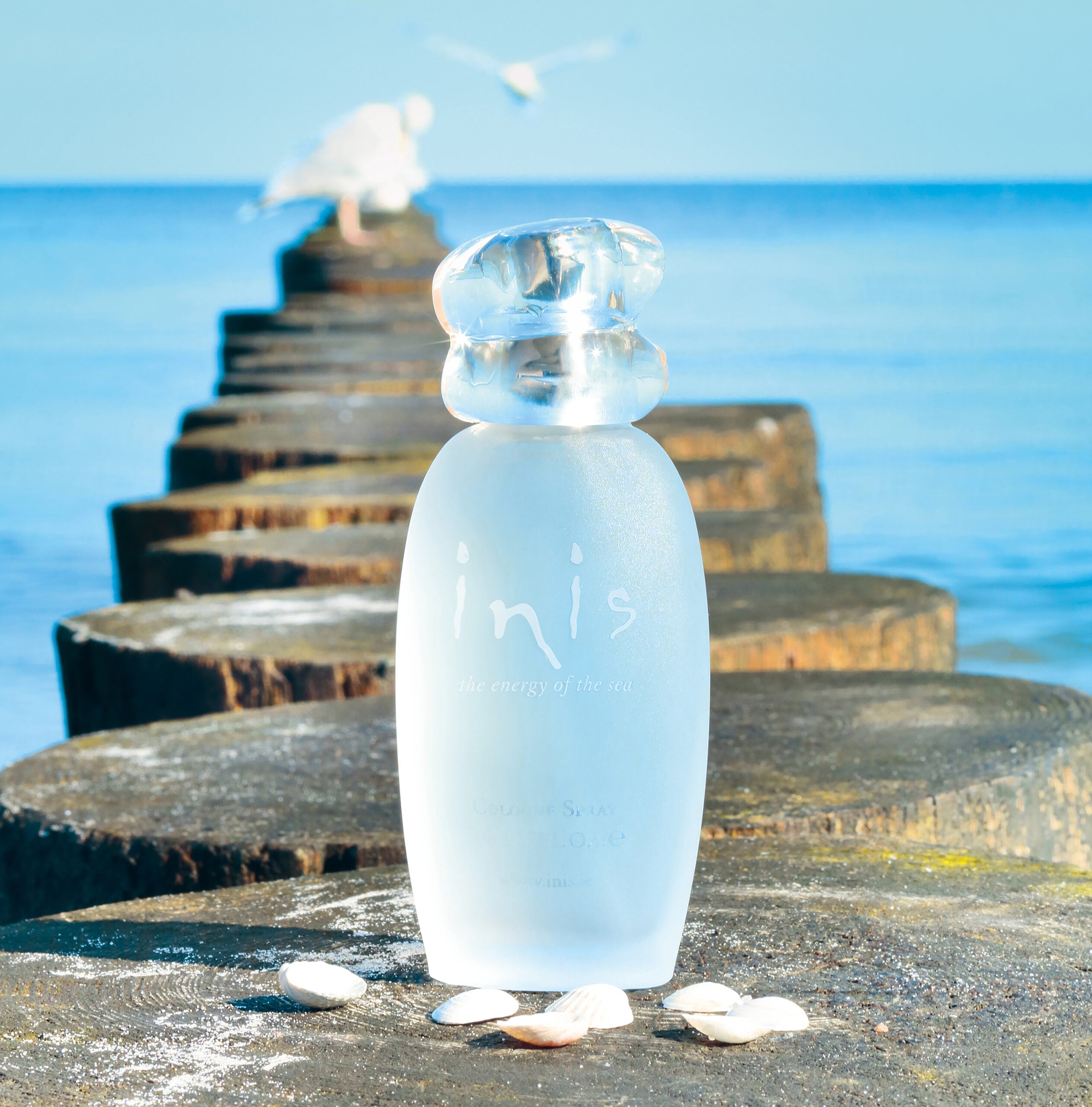 Inis cologne bottle on rocks by the sea