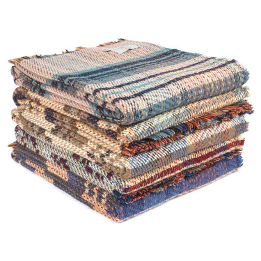 A stack of Tweedmill Recycled All Wool Throws of Various Colours on a white background.