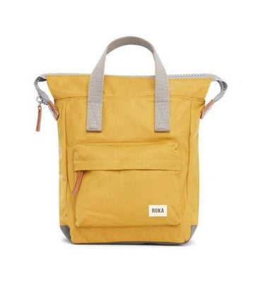A yellow Roka Bantry B Small Sustainable Nylon Bag with grey straps and handles by Roka London Bags.