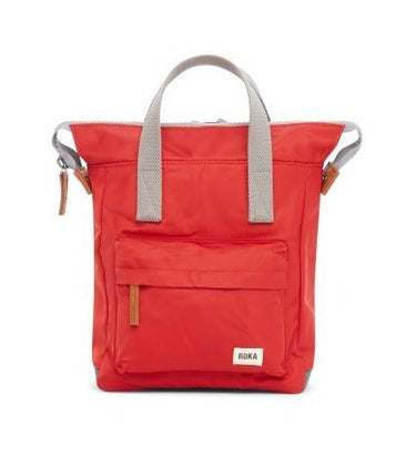 A red Roka Bantry B Small Sustainable Nylon Bag with grey straps and handles from Roka London Bags.