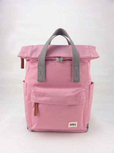 A pink Roka London Canfield B Backpack (Nylon) - Small with weather-resistant grey handles.