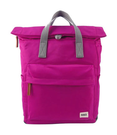 A pink Roka London Canfield B Backpack (Nylon) - Small with grey handles and straps.