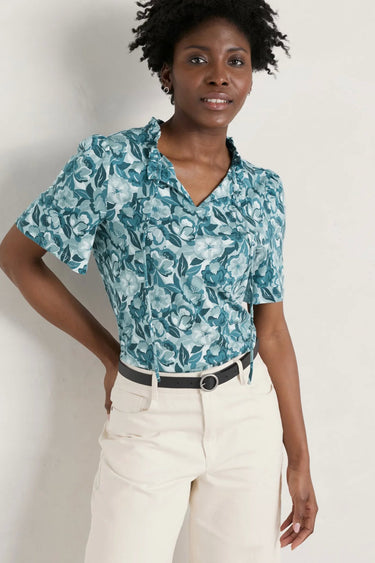 A woman in a Seasalt Anchor Hold Jersey Top floral shirt.