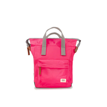 A pink Roka Bantry B Small Sustainable Nylon Bag with grey handles and straps from Roka London Bags.