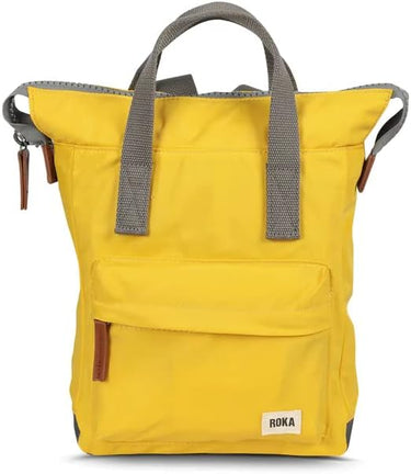 Description: A weather resistant yellow Roka Bantry B Small Sustainable Nylon Bag with grey straps and handles from Roka London Bags.